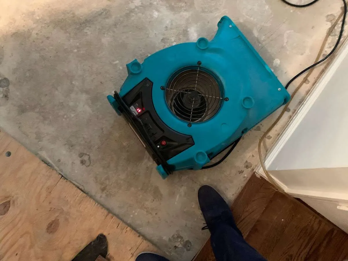 Air mover drying subfloor during Commercial Water Damage Restoration in Truth or Consequences